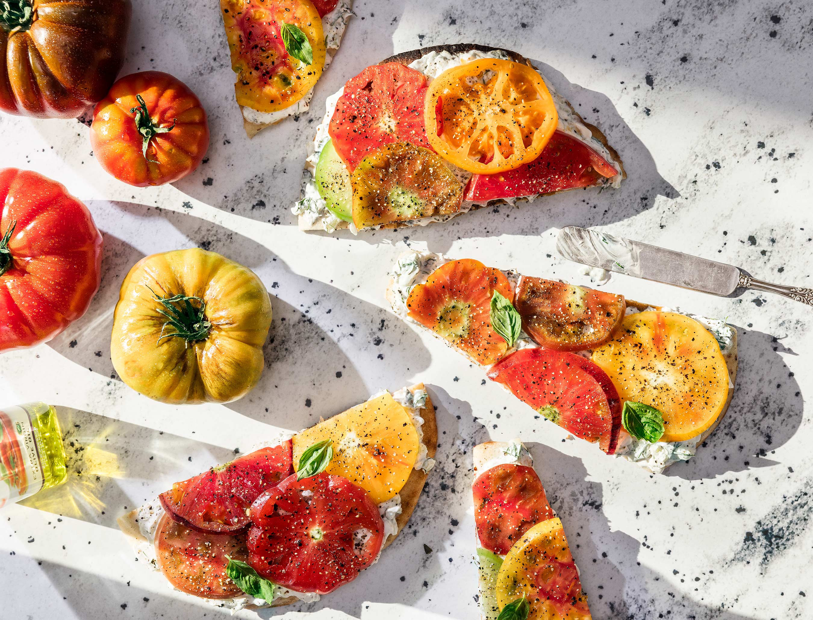 Glanger Photography | Heirloom tomatoes on toast with tzatziki sauce shot overhead