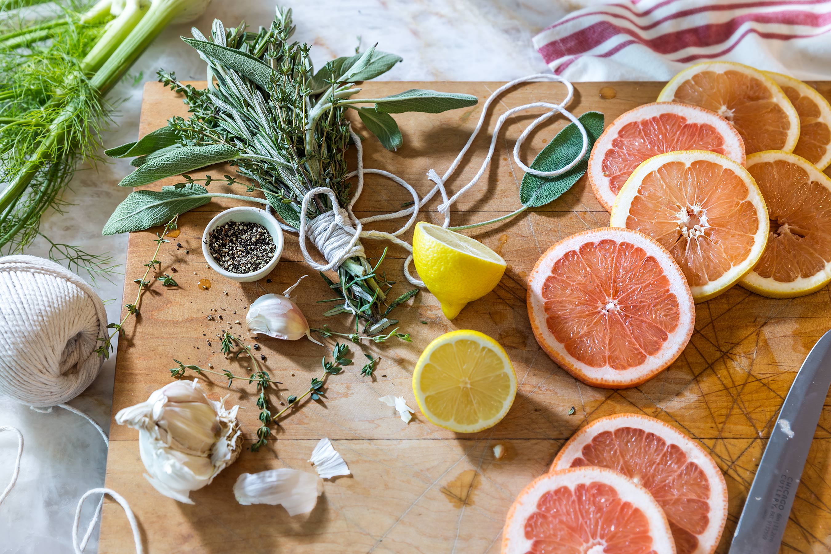 Glanger Photography | Turkey Prep board with herb bunch, grapefruit. lemons, garlic & pepper