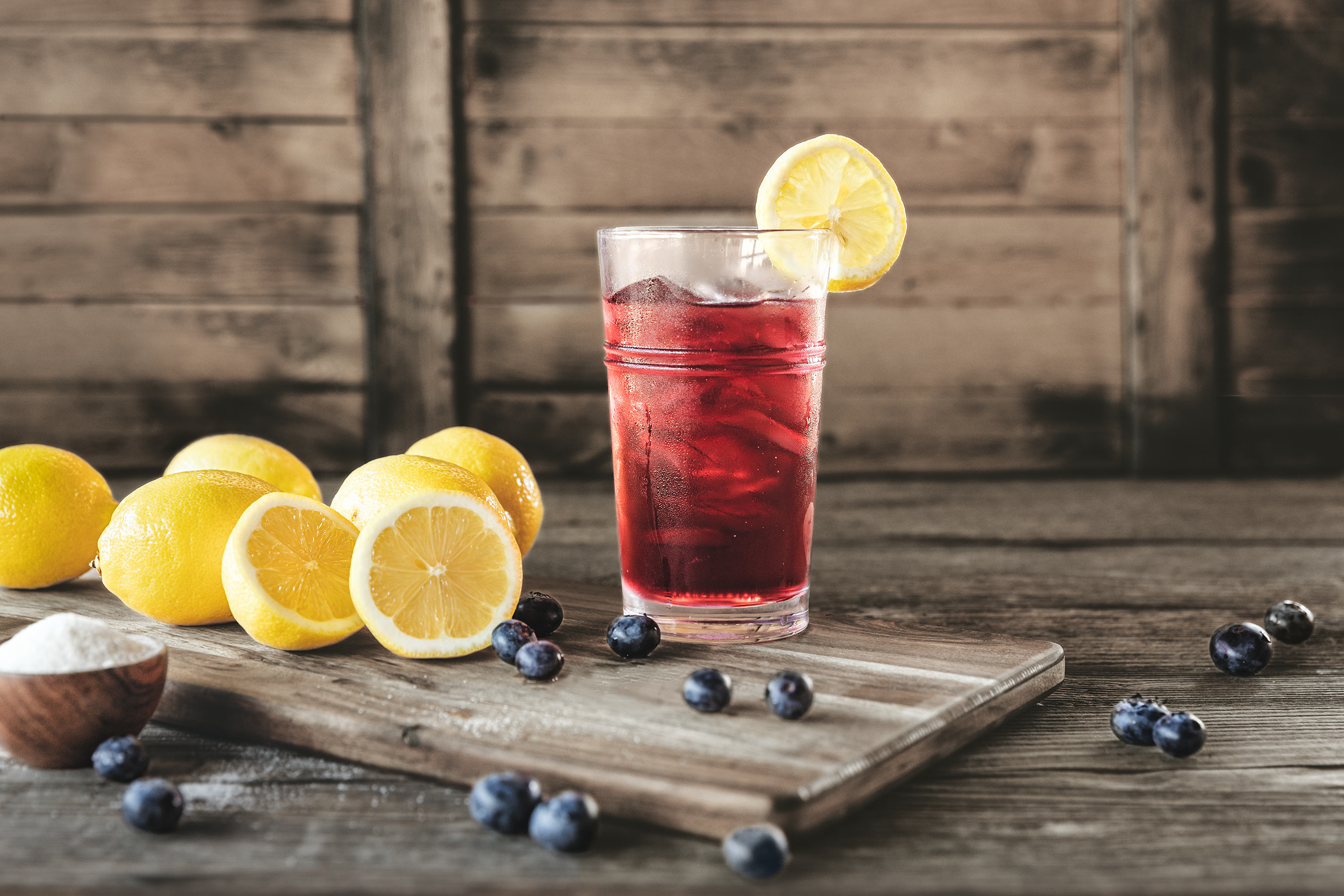 Glanger Photography | Blueberry Lemonade in a glass with ice in a rustic barn environment