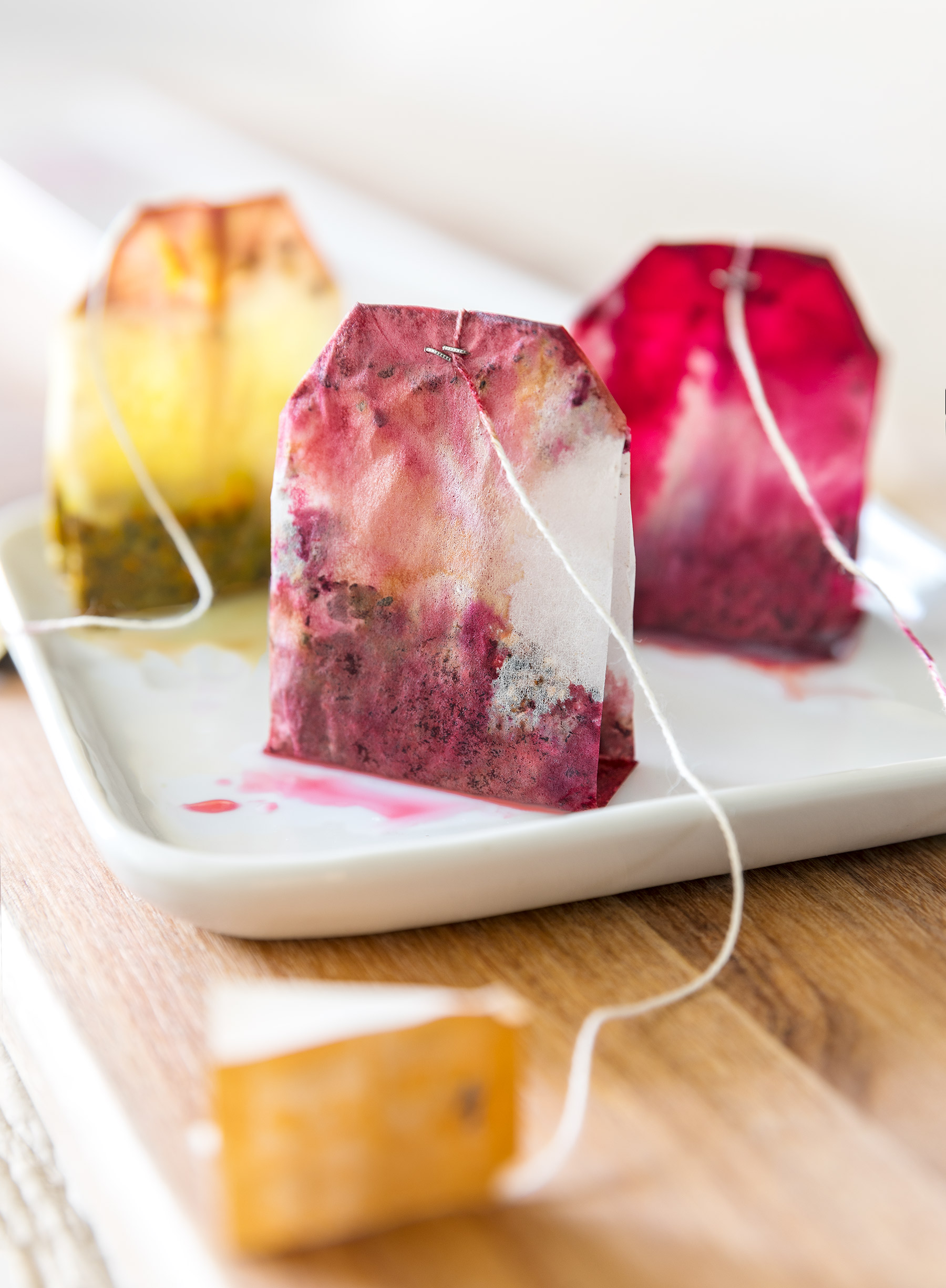 Glanger Photography | 3 steeped herbal teabags showing pink and yellow tea stains